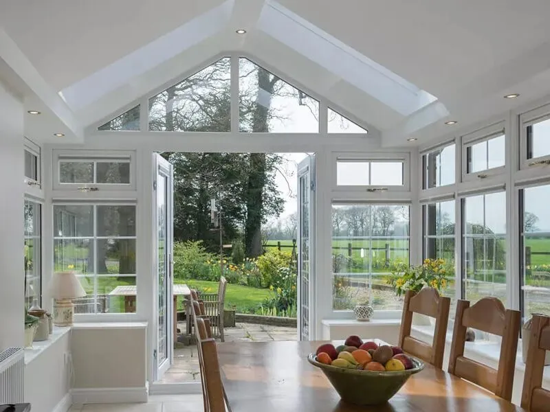 The inside of an extension with a dining table and French doors