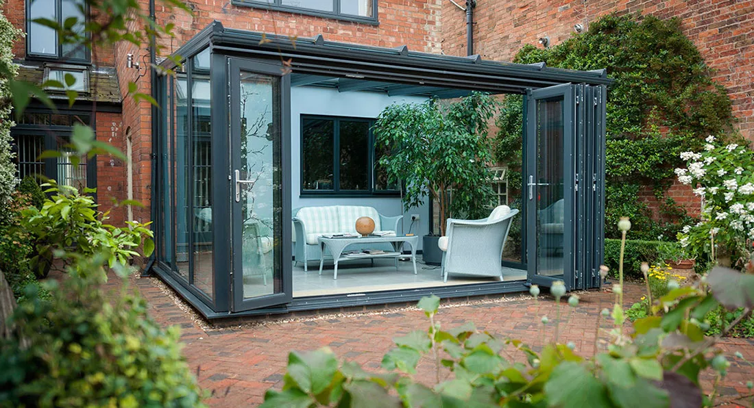 This Lean-To conservatory is compact but still very spacious and uses bi-folding doors